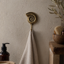 Load image into Gallery viewer, Brass Ammonite Fossil Wall Hook – Coastal Shell Hook, Beach House Bathroom Towel Hanger
